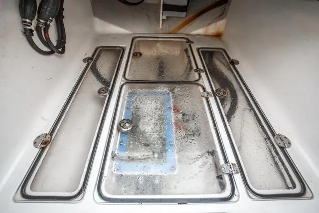 Slide: The Image of Bilge area of 2015 Bahama 34 boat with wet compartments and visible wiring. - 54