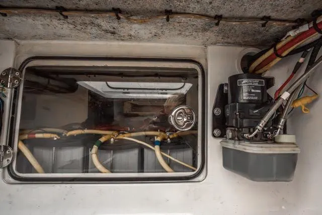 Slide: The Image of Engine compartment of 2015 Bahama 34 boat with visible wiring and components. - 56