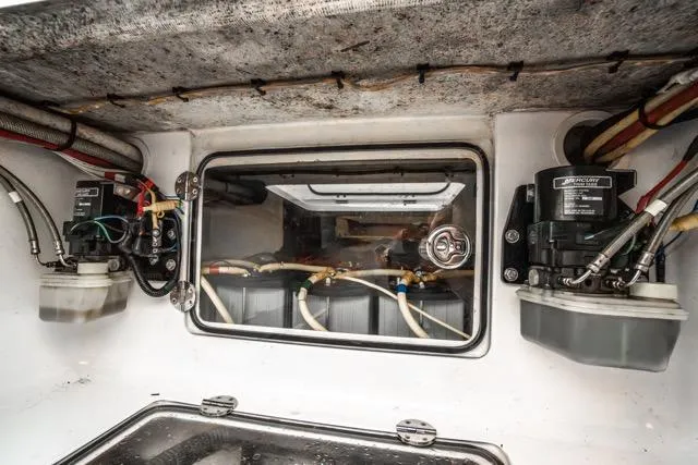 Slide: The Image of 2015 Bahama 34 boat interior showing mechanical components and wiring. - 57