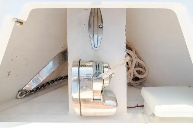 Slide: The Image of Anchor compartment of 2015 Bahama 34 boat with chain and rope. - 58