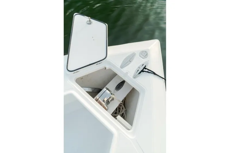 Slide: The Image of Open anchor compartment on 2015 Bahama 34 boat, showing anchor and rope storage. - 59