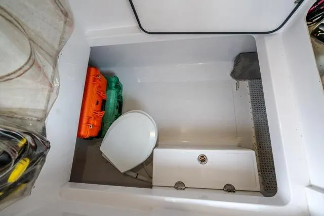 Slide: The Image of 2015 Bahama 34 boat interior with storage, toilet, and equipment cases. - 63