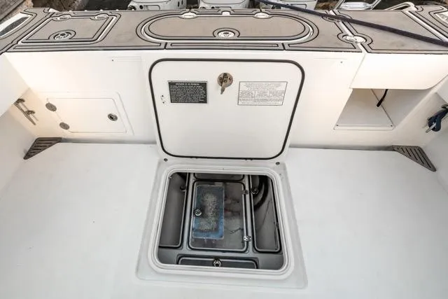 Slide: The Image of 2015 Bahama 34 boat deck with open storage compartment. - 51