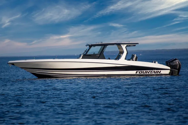 Slide: The Image of Manufacturer Provided Image: 2025 Fountain 39 SCX boat on calm water under a blue sky. - 2