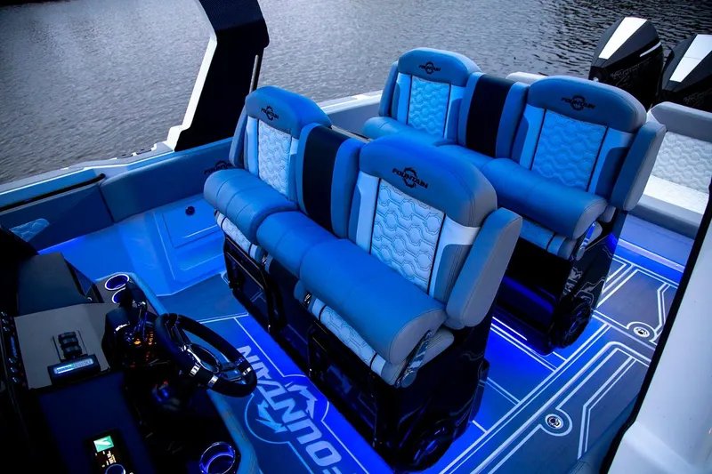 Slide: The Image of Manufacturer Provided Image: 2025 Fountain 39 SCX boat interior with blue illuminated seating and modern design. - 5