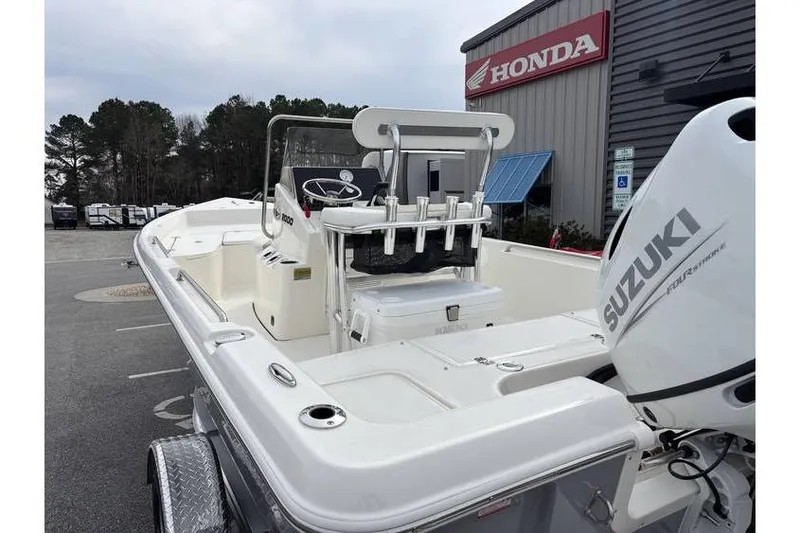 Slide: The Image of 2026 Bulls Bay 2000 boat with Suzuki engine, parked near Honda dealership. - 11