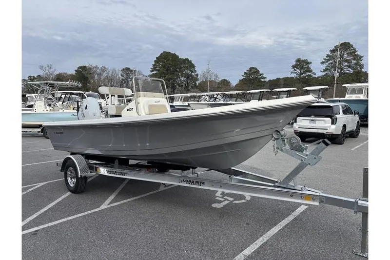 Slide: The Image of 2026 Bulls Bay 2000 boat on trailer in parking lot, surrounded by trees and vehicles. - 4