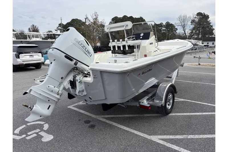 Slide: The Image of 2026 Bulls Bay 2000 boat with Suzuki outboard motor on a trailer in a parking lot. - 7
