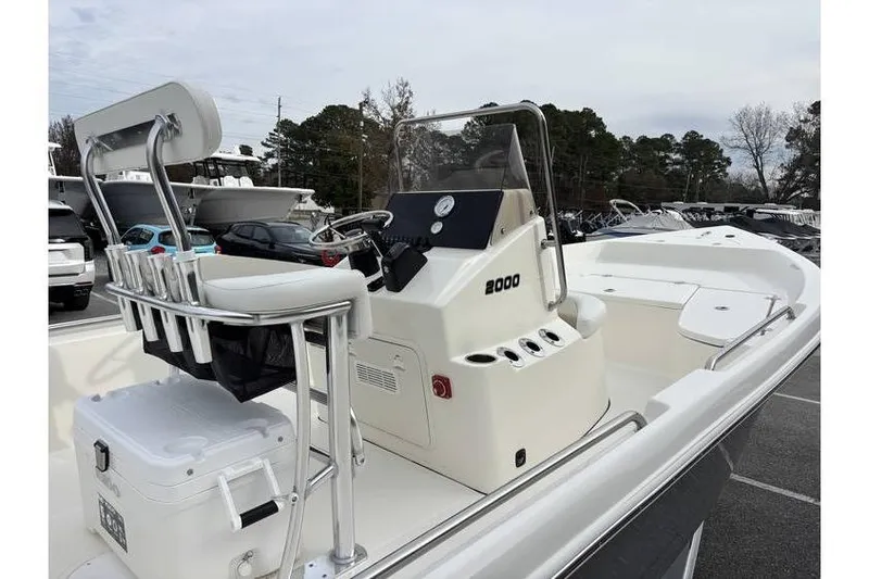 Slide: The Image of 2026 Bulls Bay 2000 boat with center console and seating, parked outdoors. - 8