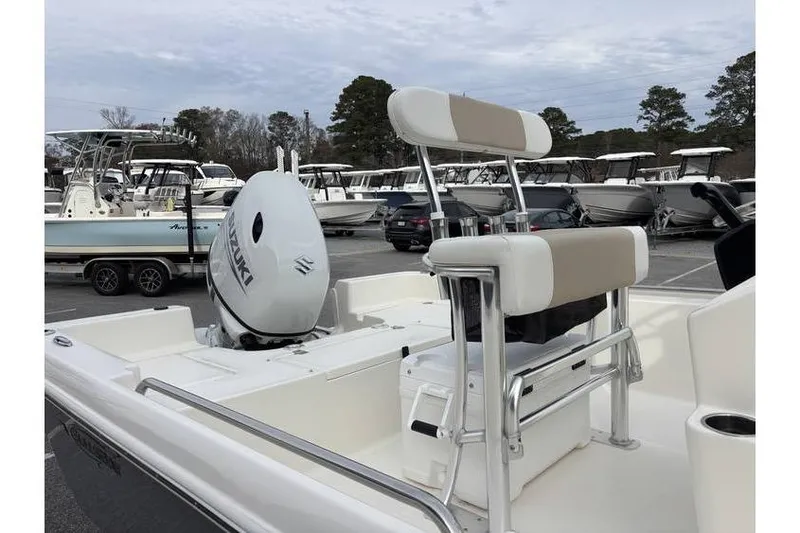 Slide: The Image of 2026 Bulls Bay 2000 boat with Suzuki outboard motor in a marina setting. - 9