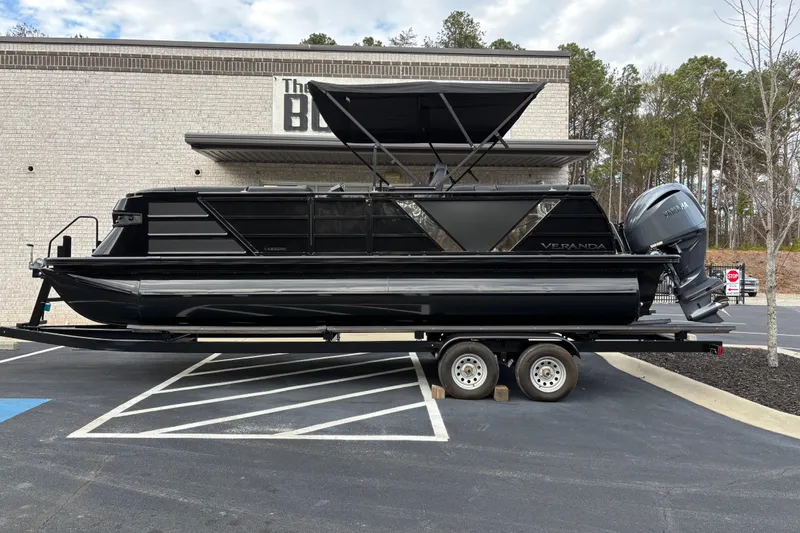 The Image of 2026 Veranda Vertex 235RC Premium pontoon boat on trailer, parked outdoors. - 1