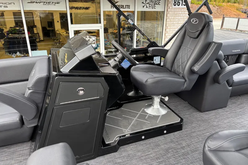 Slide: The Image of 2026 Veranda Vertex 235RC Premium boat interior with luxurious captain's chair and sleek dashboard. - 9