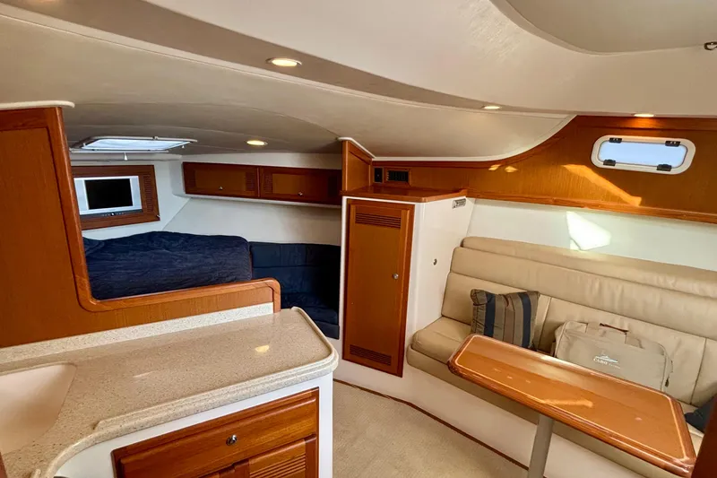 Slide: The Image of 2004 Cabo 35 Express Sportfish bathroom with shower, sink, and porthole window. - 10