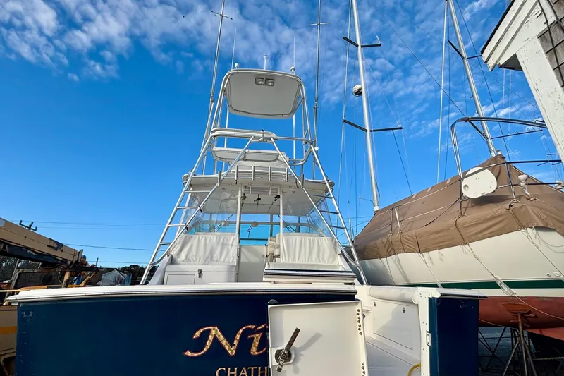 Slide: The Image of 2004 Cabo 35 Express Sportfish boat deck with seating and a central table. - 3