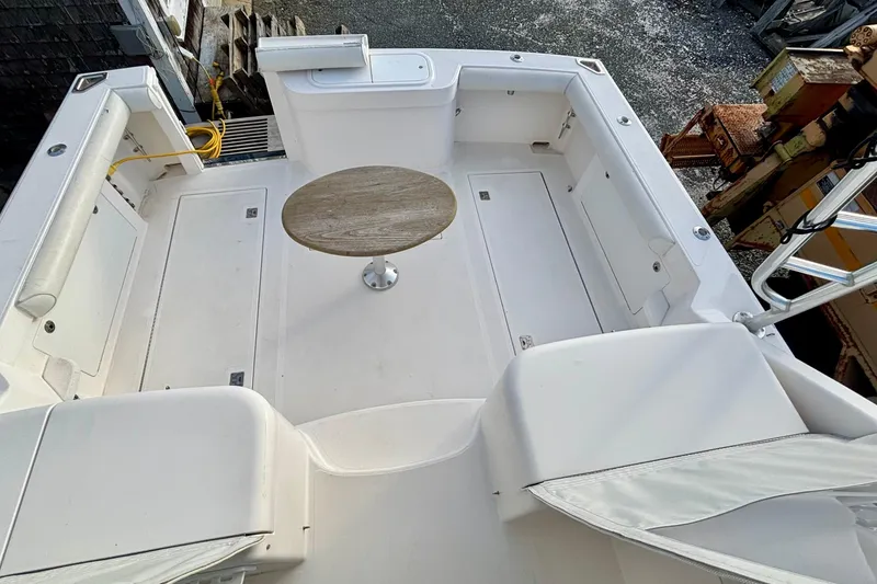 Slide: The Image of 2004 Cabo 35 Express Sportfish helm with white seating and navigation equipment. - 4