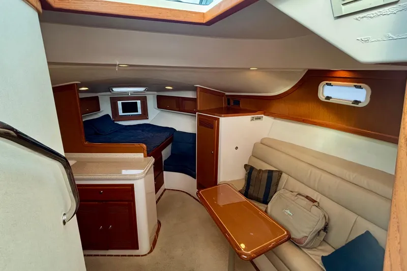 Slide: The Image of Luxurious interior of 2004 Cabo 35 Express Sportfish with kitchen and sleeping area. - 7