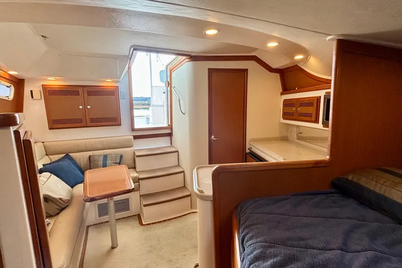 Slide: The Image of 2004 Cabo 35 Express Sportfish interior with cozy seating and modern amenities. - 9
