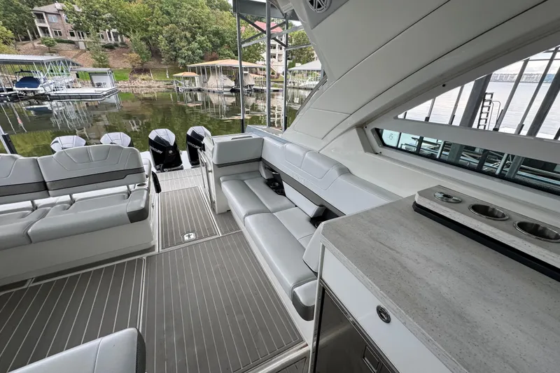 Slide: The Image of 2020 Formula 400 Super Sport Crossover boat interior with seating and dock view. - 19