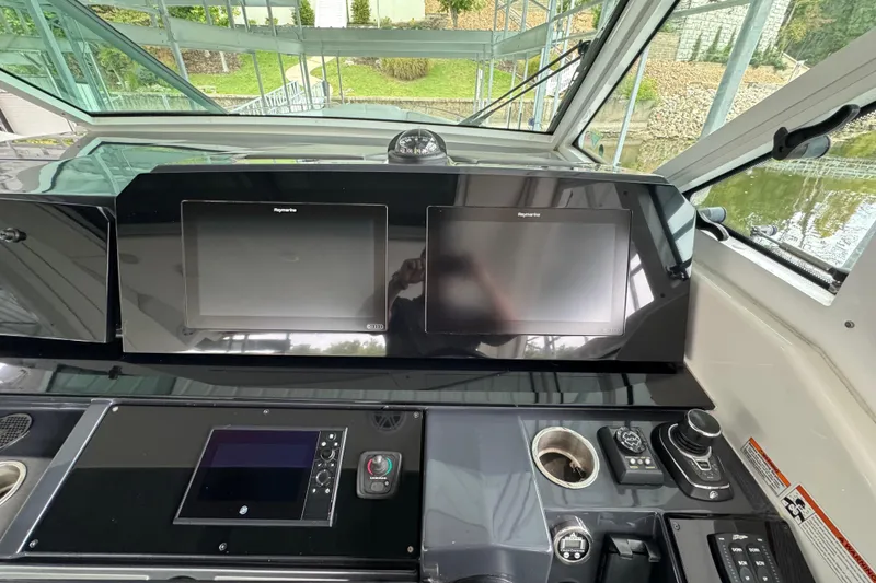 Slide: The Image of 2020 Formula 400 Super Sport Crossover helm with dual Raymarine displays and controls. - 38