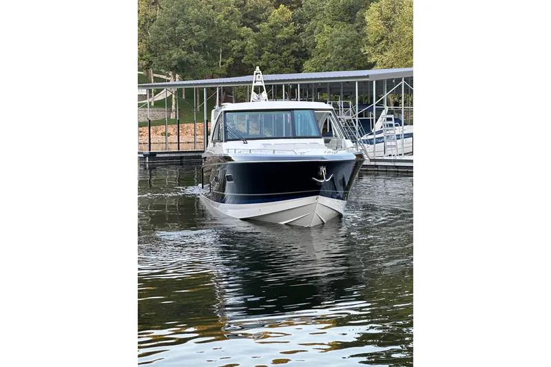 Slide: The Image of 2020 Formula 400 Super Sport Crossover yacht docked on calm water. - 6