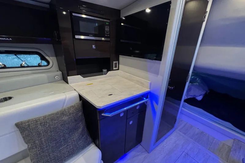 Slide: The Image of Interior of 2020 Formula 400 Super Sport Crossover with modern kitchenette and seating area. - 9