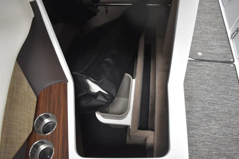 Slide: The Image of 2021 Cobalt R7 boat interior storage compartment with fabric lining and cup holders. - 10