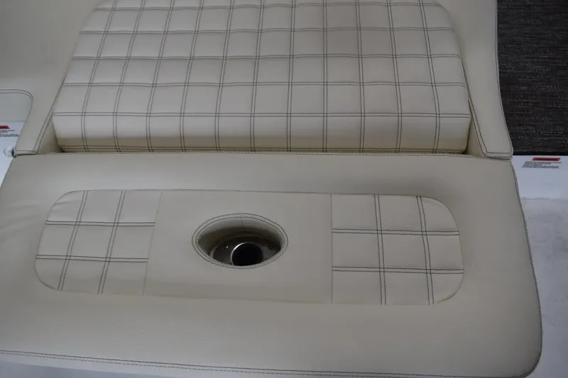 Slide: The Image of 2021 Cobalt R7 boat seat with beige upholstery and cup holder. - 2