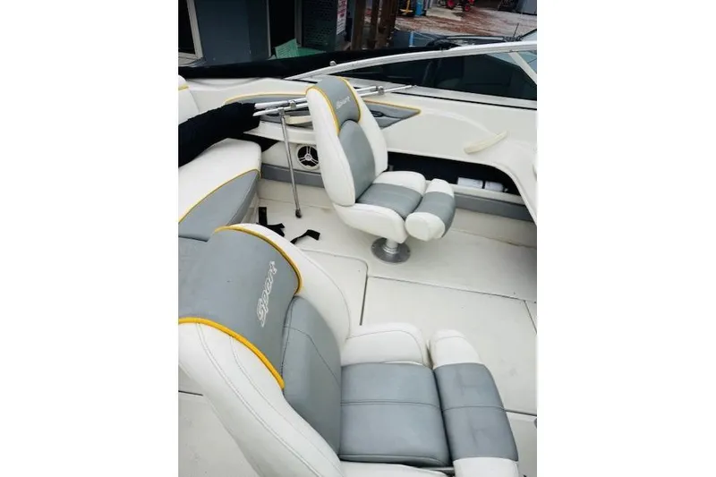 Slide: The Image of 2008 Sea Ray 205 Sport boat interior with gray and white seating. - 12