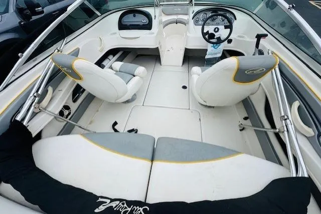 Slide: The Image of 2008 Sea Ray 205 Sport boat interior with white and gray seating, steering wheel, and dashboard. - 14