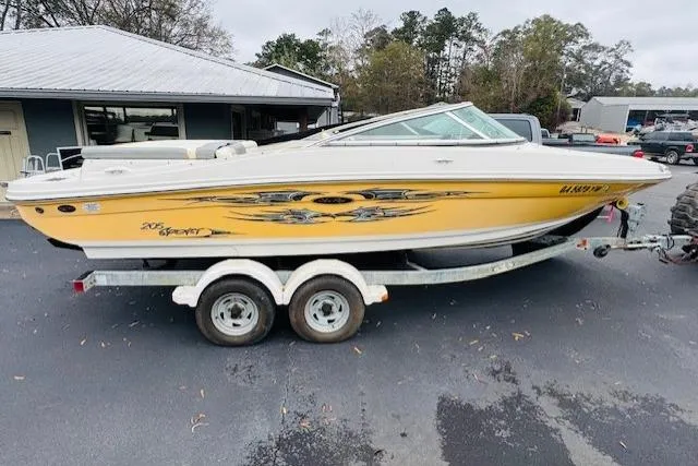 Slide: The Image of 2008 Sea Ray 205 Sport boat on trailer, yellow with custom graphics, parked outdoors. - 15