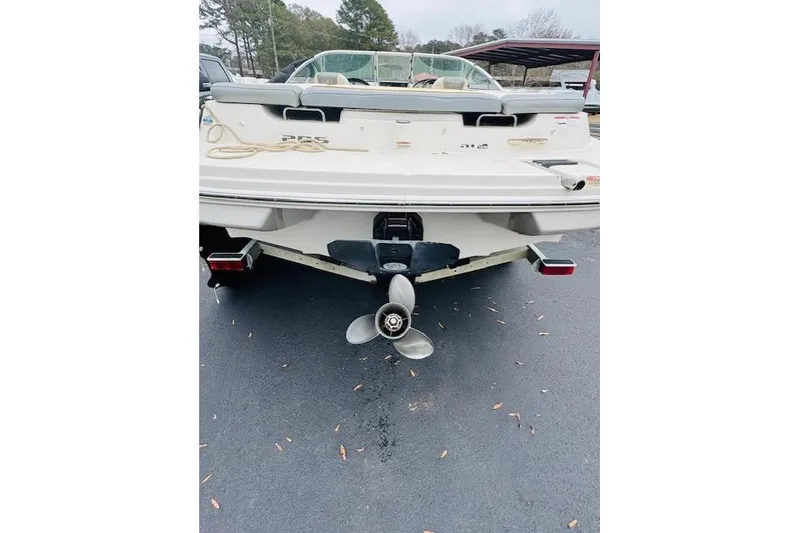 Slide: The Image of 2008 Sea Ray 205 Sport boat rear view with propeller on asphalt. - 16