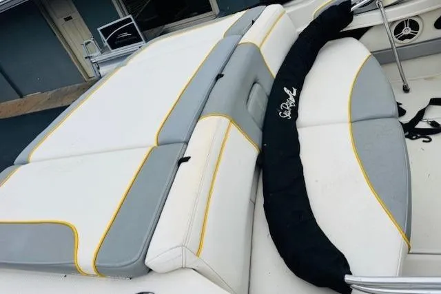 Slide: The Image of 2008 Sea Ray 205 Sport boat interior with white and gray seating, yellow accents. - 7