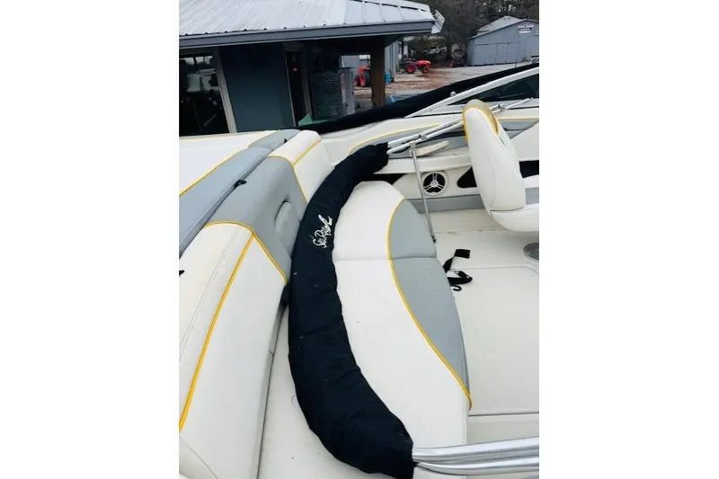 Slide: The Image of 2008 Sea Ray 205 Sport boat interior with cushioned seating and protective cover. - 8