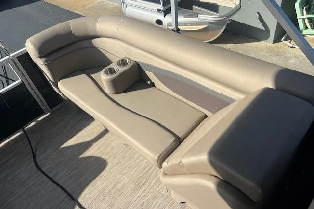 Slide: The Image of 2021 Bennington 22 SSRX boat interior with beige seating and cup holders. - 6