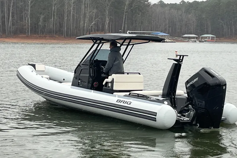 Slide: The Image of 2026 Brig Eagle 8 boat on a lake with a Mercury outboard motor. - 12