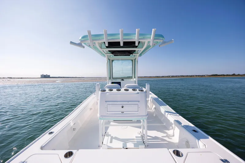 Slide: The Image of Caymas 26 HB 2026 boat on calm water under sunny sky. - 12