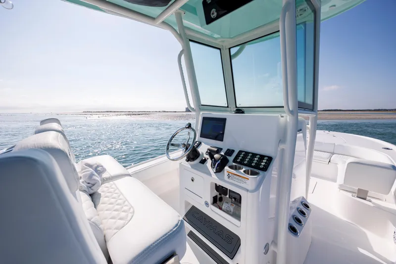 Slide: The Image of Interior of 2026 Caymas 26 HB boat on the water. - 13