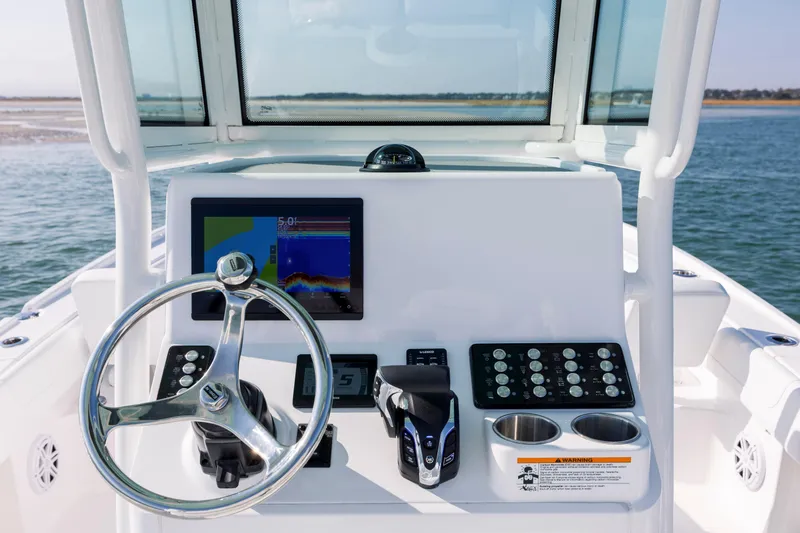 Slide: The Image of 2026 Caymas 26 HB helm console on open water. - 16