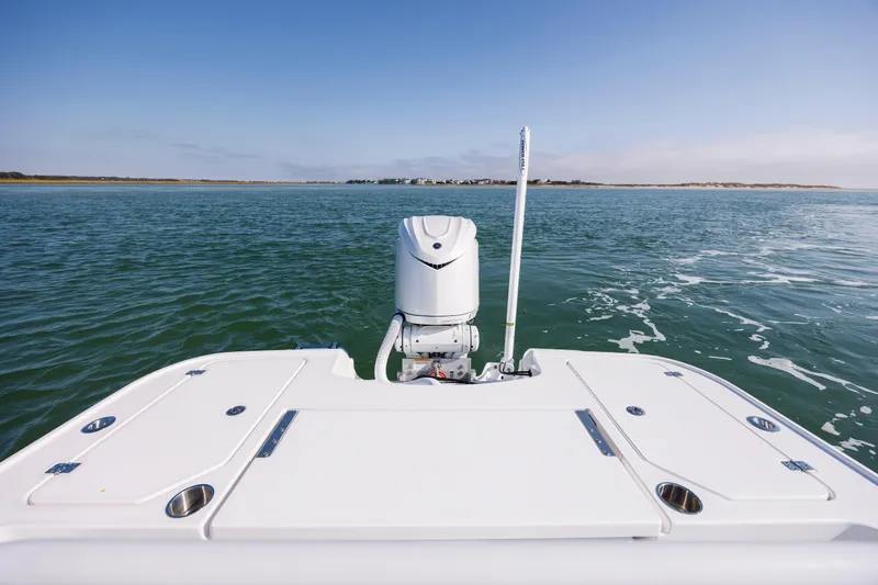 Slide: The Image of Caymas 26 HB 2026 on calm water with clear sky. - 21