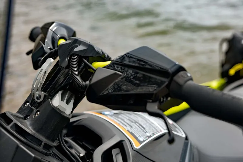 Slide: The Image of Manufacturer Provided Image: Close-up of 2026 Sea-Doo Explorer Pro 170 handlebars by the water. - 5