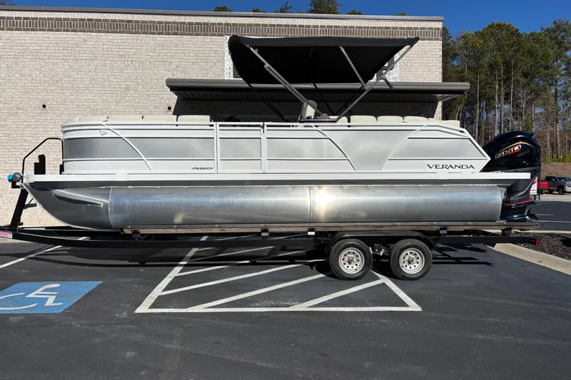 The Image of 2026 Veranda Relax VR 235 RCP pontoon boat on trailer, parked in a lot. - 0