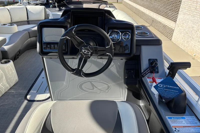 Slide: The Image of 2026 Veranda Relax VR 235 RCP boat dashboard with steering wheel and controls. - 10