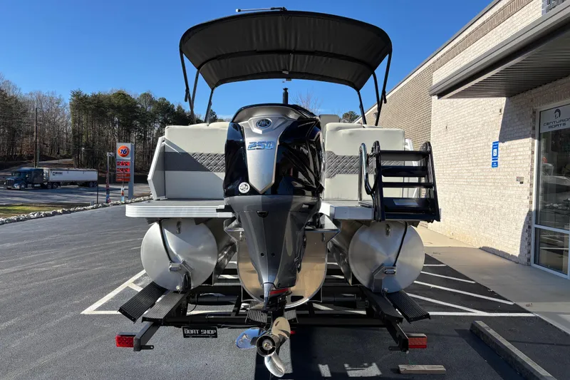 Slide: The Image of 2026 Veranda Relax VR 235 RCP pontoon boat with powerful outboard motor, parked outdoors. - 4