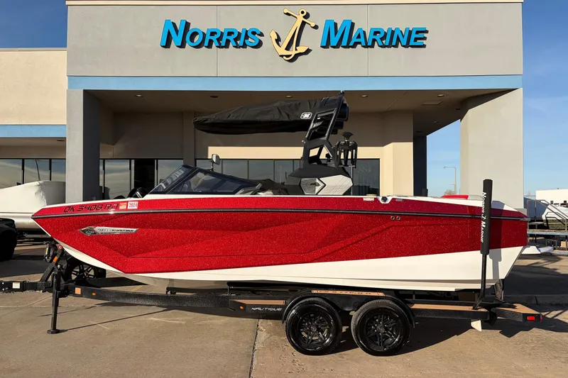 The Image of 2021 Nautique Super Air Nautique G23 boat in red, displayed at Norris Marine dealership. - 1