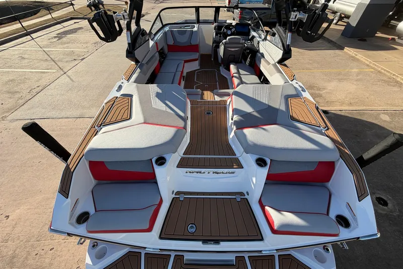 Slide: The Image of 2021 Nautique Super Air Nautique G23 boat interior with stylish seating and wood accents. - 10