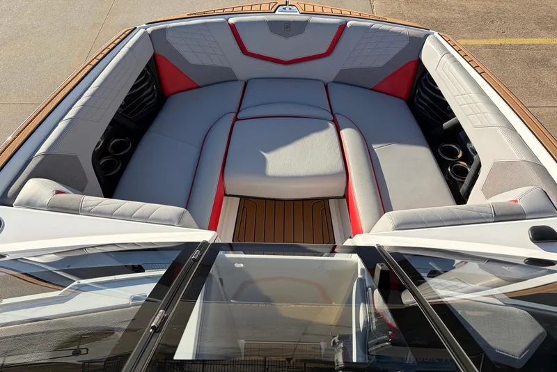Slide: The Image of 2021 Nautique Super Air Nautique G23 boat interior with gray and red seating. - 12