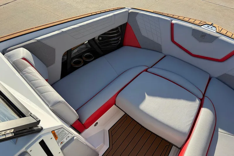 Slide: The Image of 2021 Nautique Super Air Nautique G23 boat interior with gray and red seating. - 13
