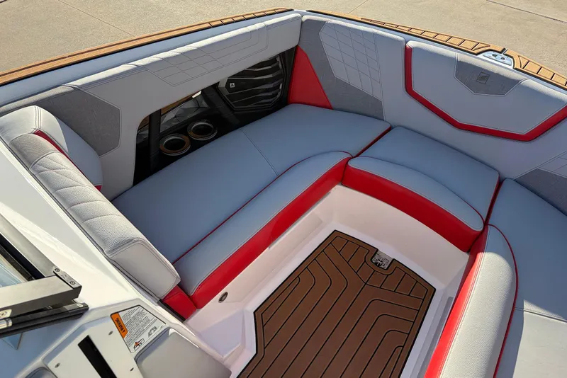 Slide: The Image of 2021 Nautique Super Air Nautique G23 interior with red and gray seating. - 16