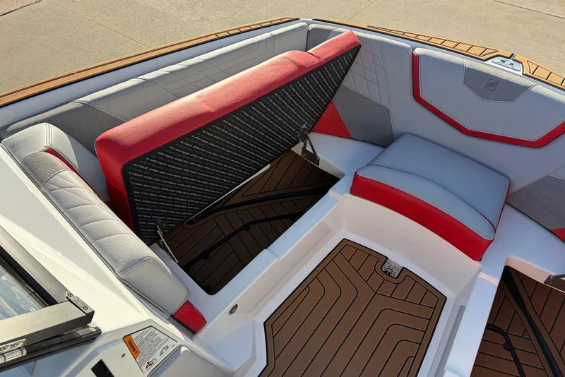 Slide: The Image of 2021 Nautique Super Air Nautique G23 interior seating with red and gray upholstery. - 18