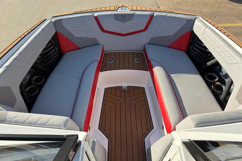 Slide: The Image of 2021 Nautique Super Air Nautique G23 boat interior with red and gray seating. - 20